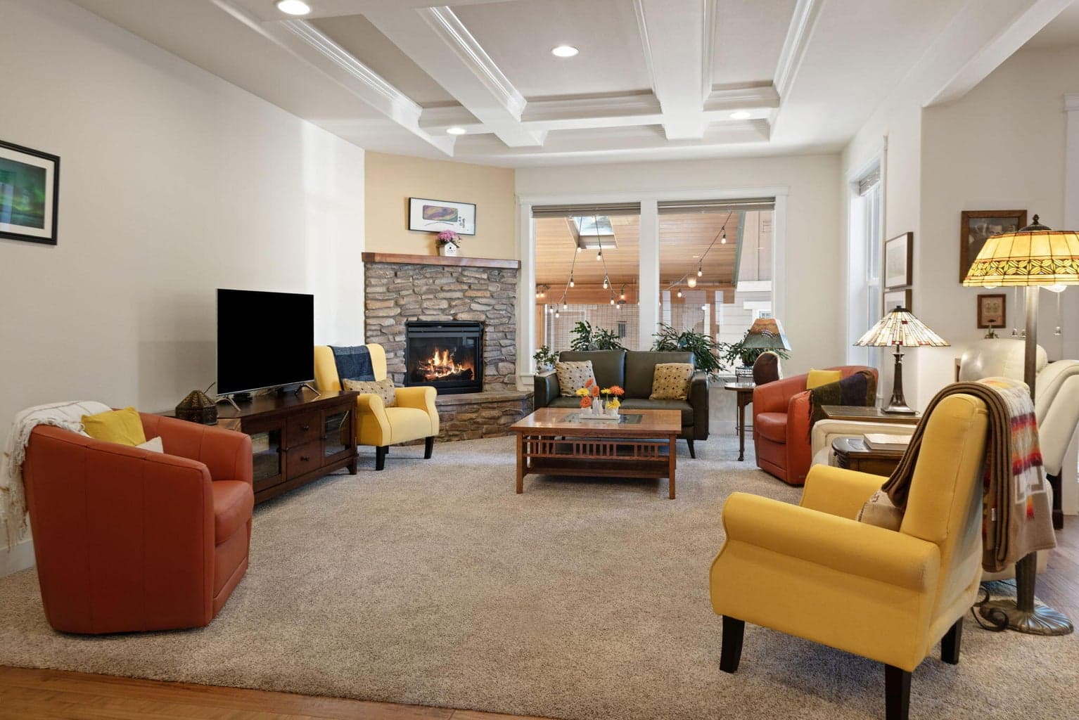 Open living room with walls of windows.