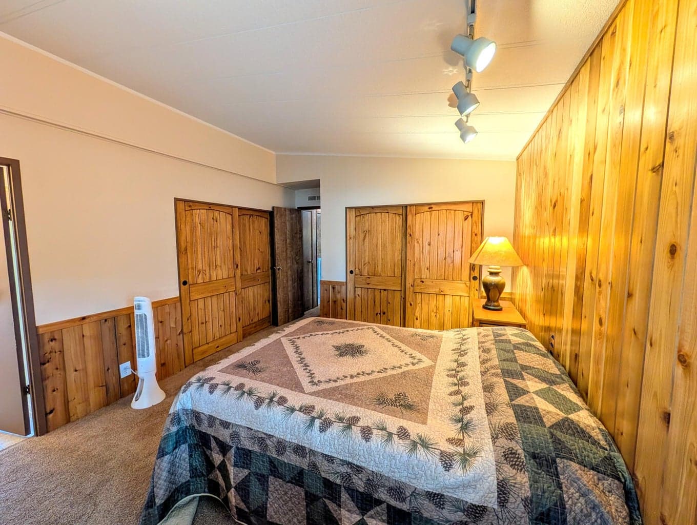 Primary Bedroom with tongue and groove feature wall and solid wood doors