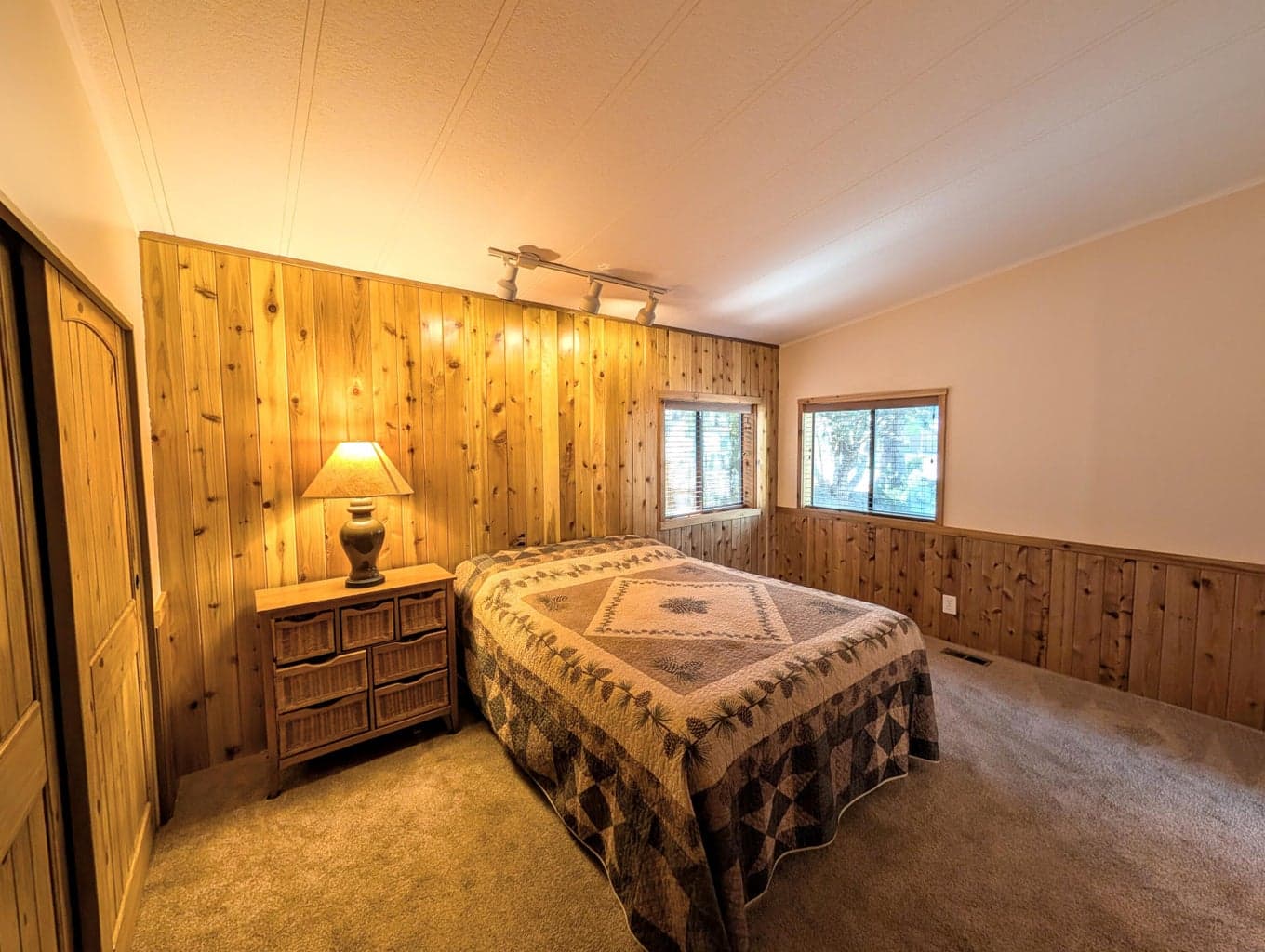 Primary Bedroom with tongue and groove feature wall and solid wood doors