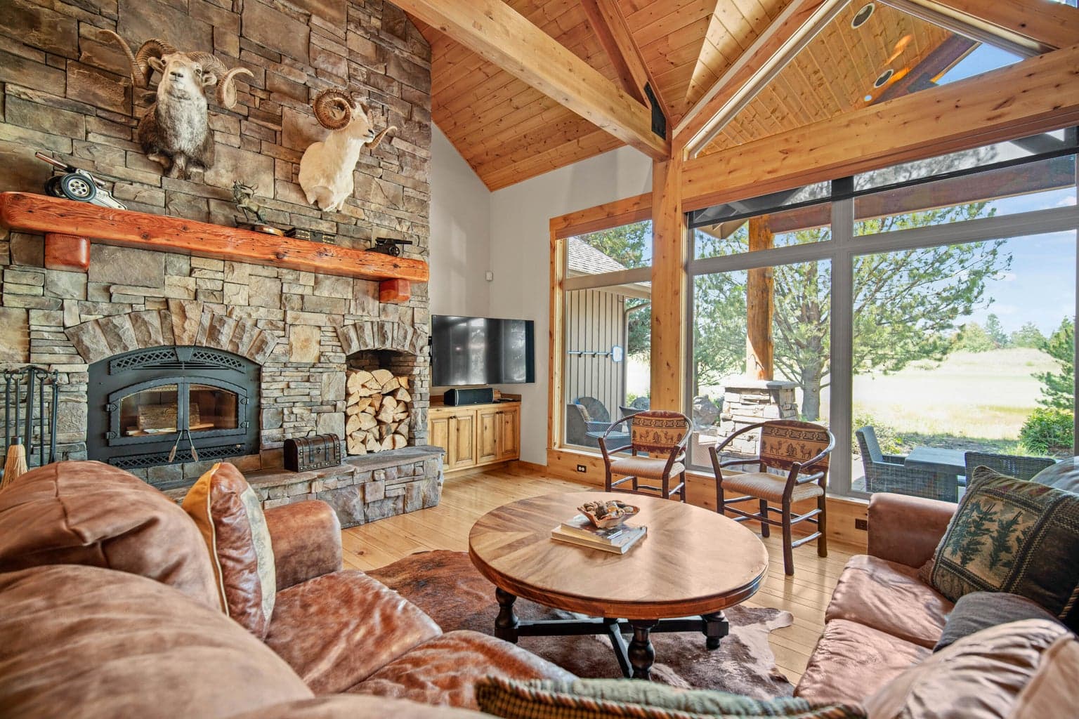 Floor-to-ceiling stacked stone fireplace anchors the great room, adding warmth and classic Central Oregon lodge character.