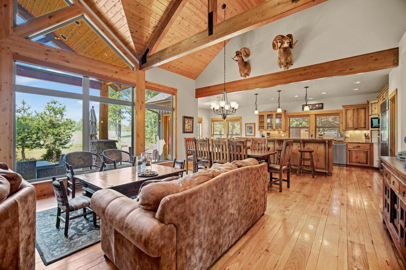 Open living, dining, and kitchen layout designed for gathering, entertaining, and easy indoor-outdoor enjoyment.