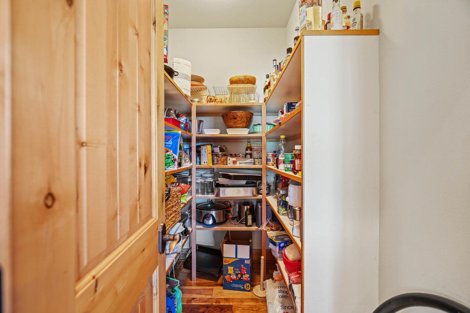 Large walk-in pantry adds practical storage for extended stays, entertaining, and resort living.