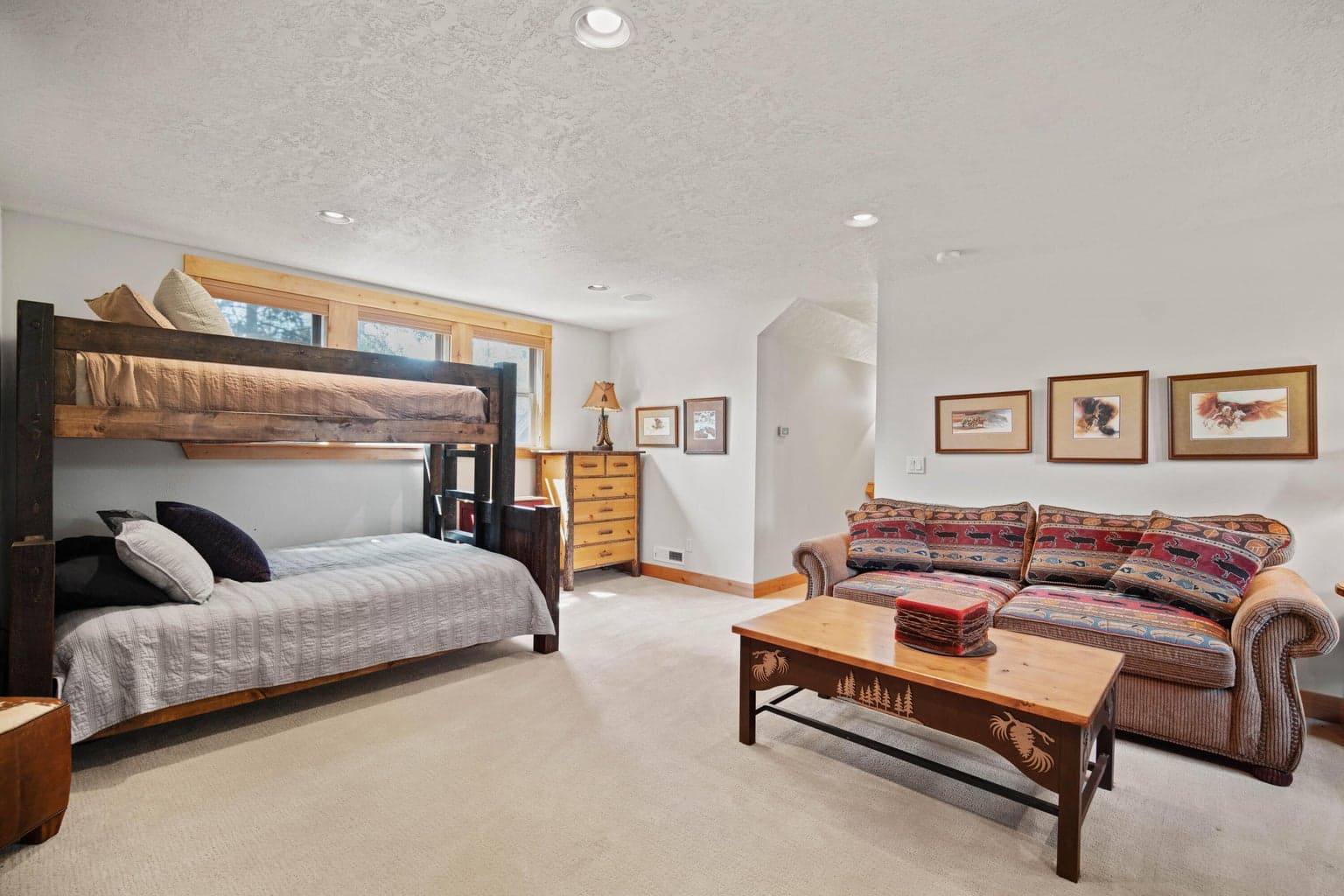 Bonus-level lounge with bunk beds, sofa seating, and room for extended family or guests.