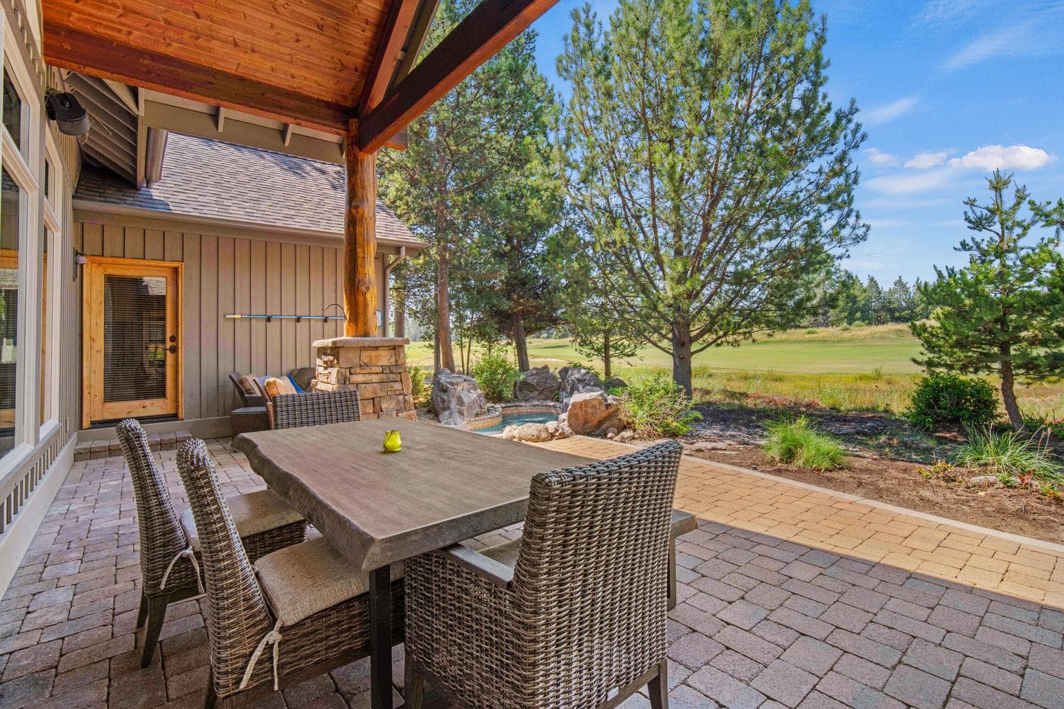 The large, covered, paver patio overlooks Caldera Links.