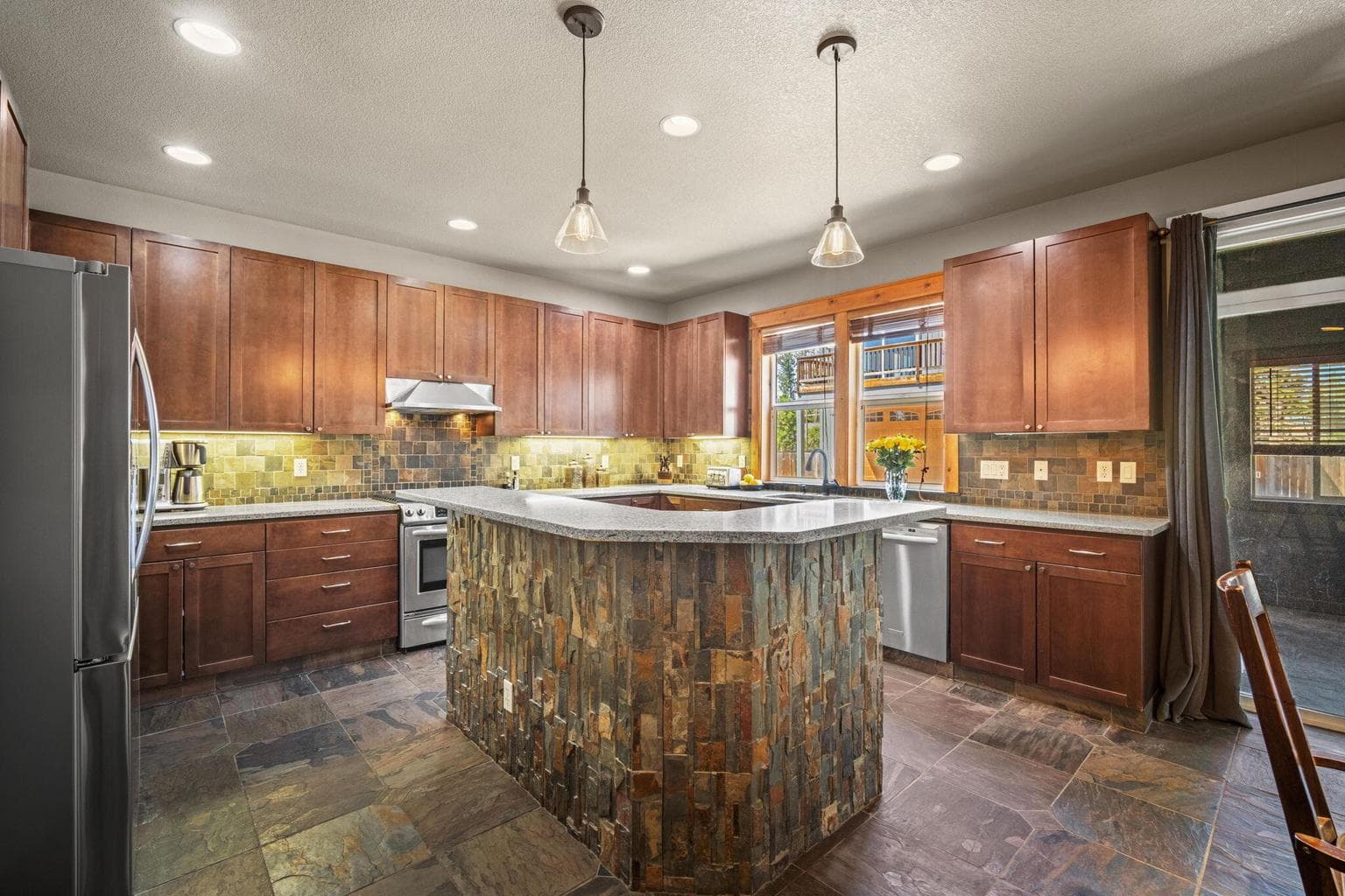 An amazing kitchen with slate, tile and stone accents