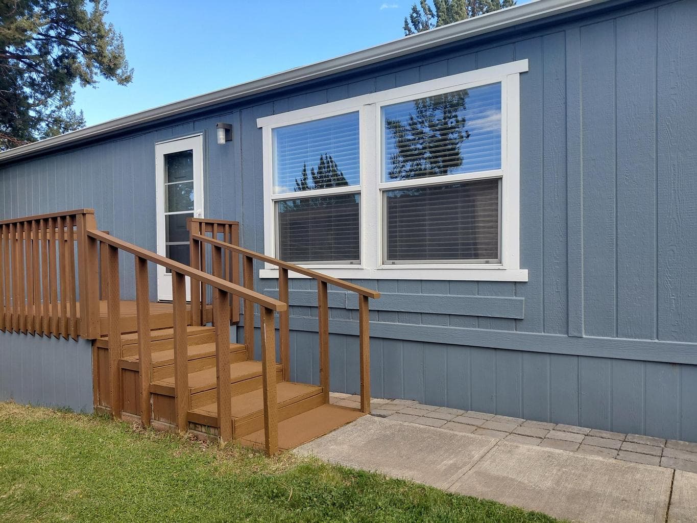 Front porch, new storm door, exterior paint, roof, and skirting .