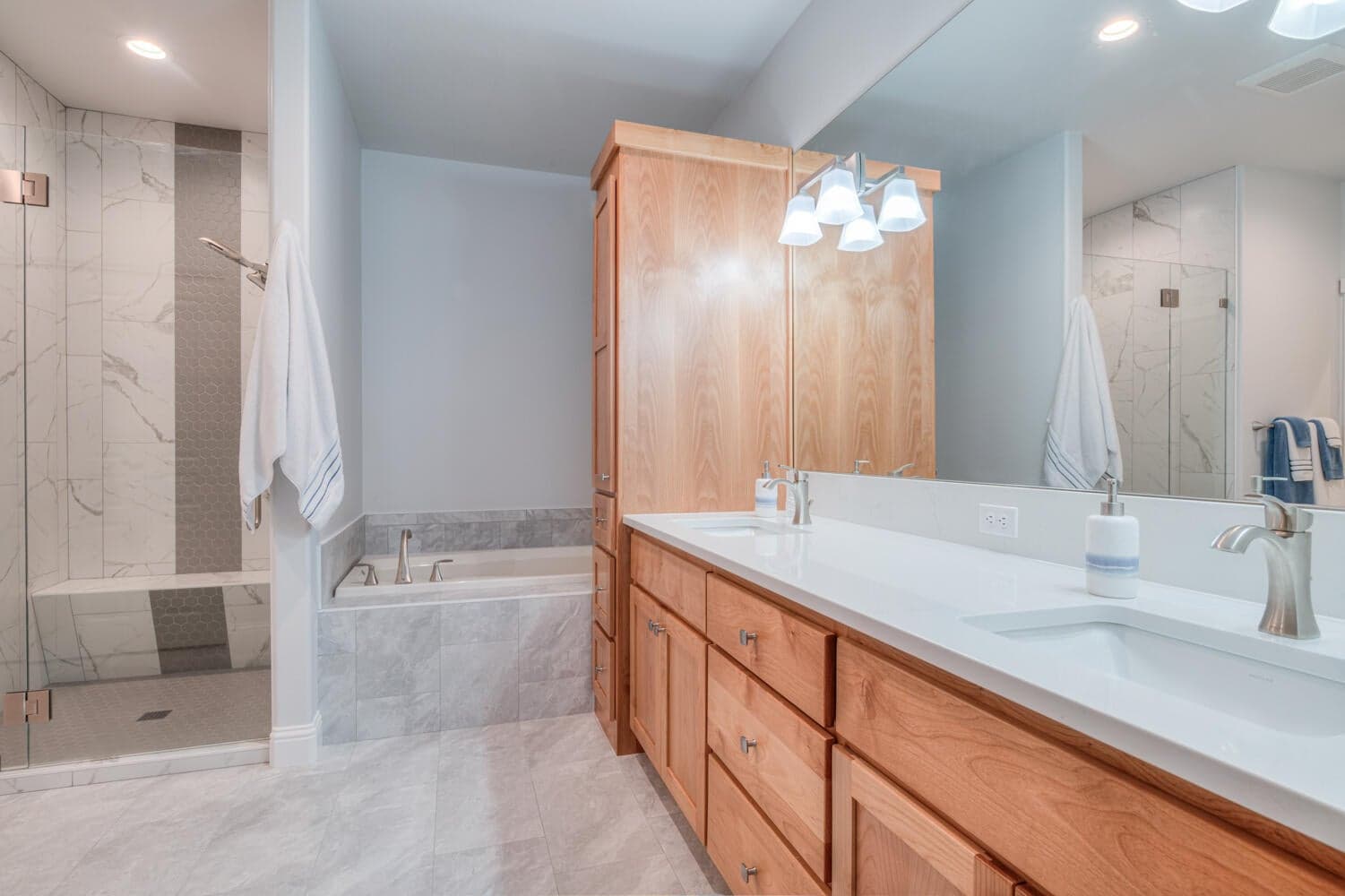 Primary Bath with new Quartz counters, added cabinet and tile floor
