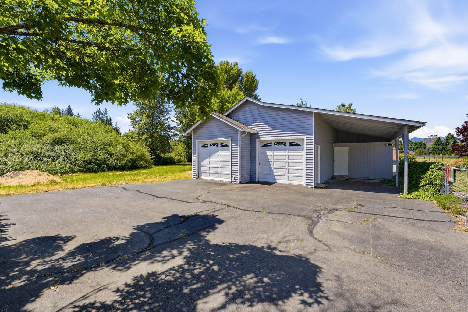 Extra garage parking with shop area, RV parking/car port and separate storage area