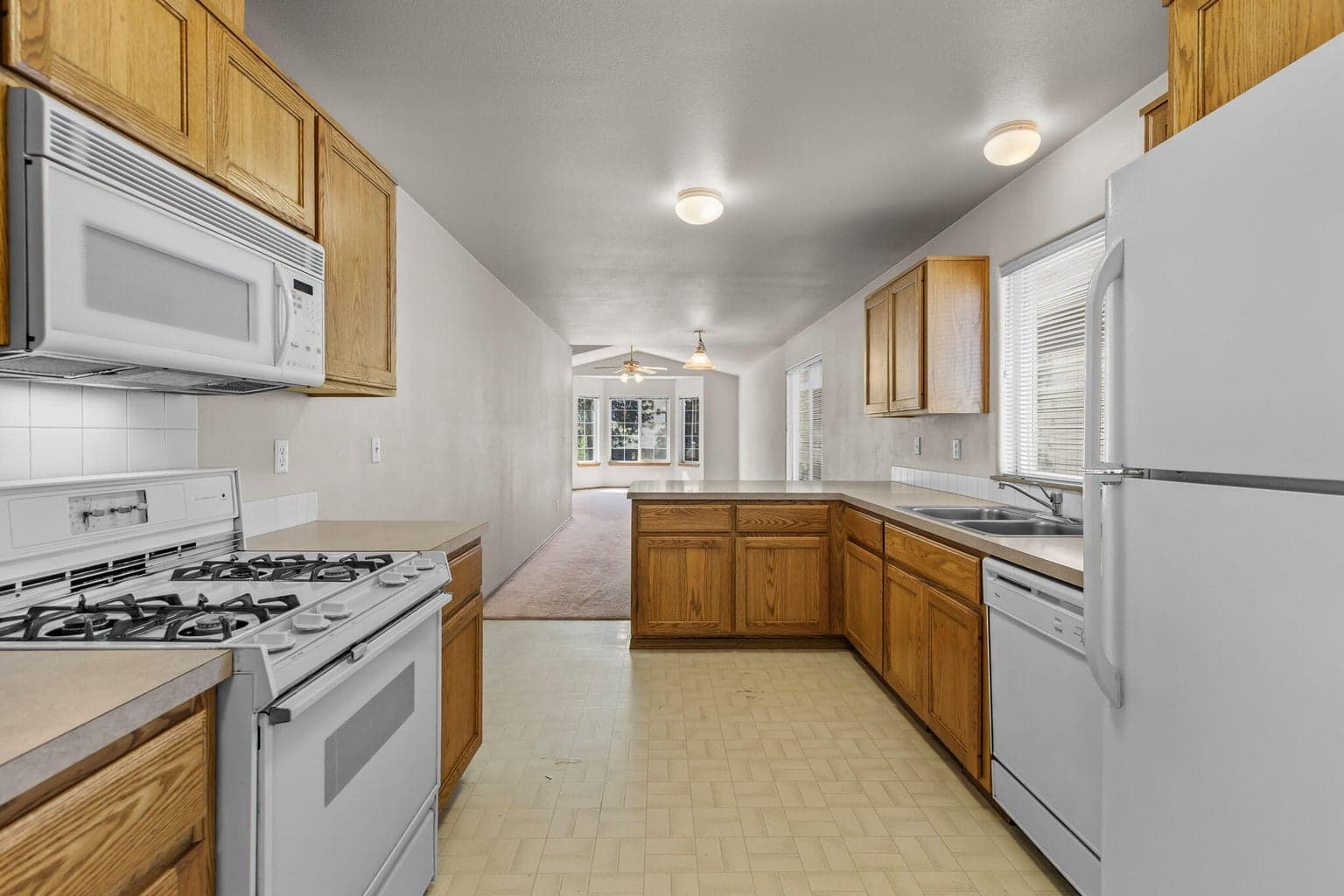 Open kitchen layout w/ample cabinetry for storage.