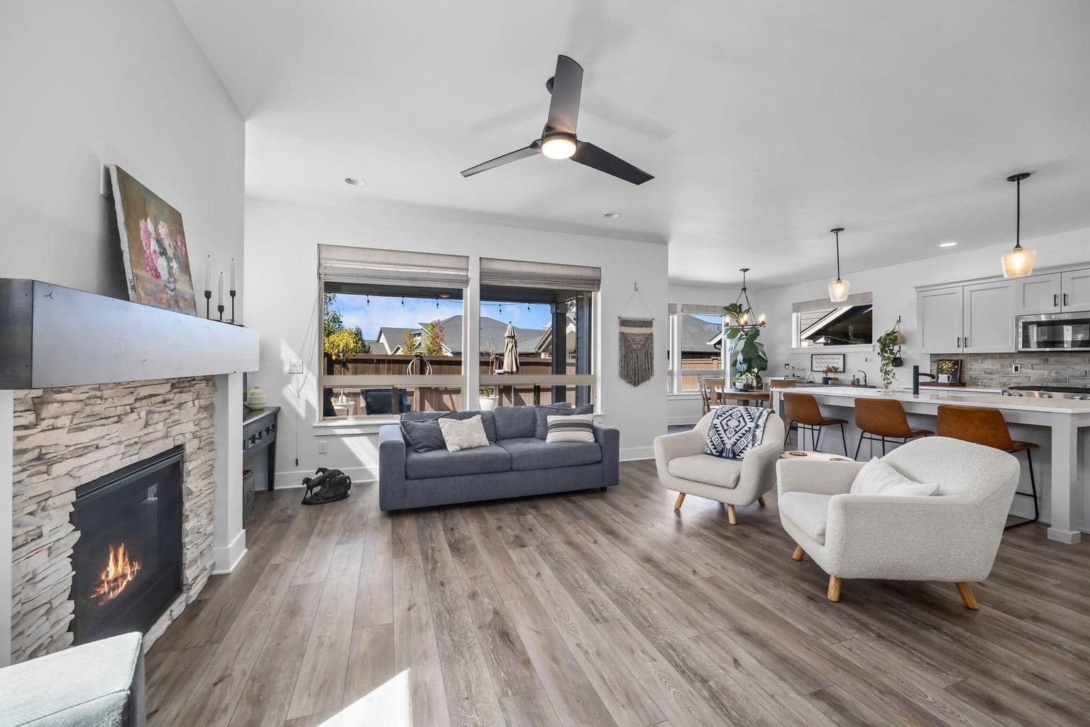 Soaring ceilings & stacked-stone fireplace anchor this stunning great room.