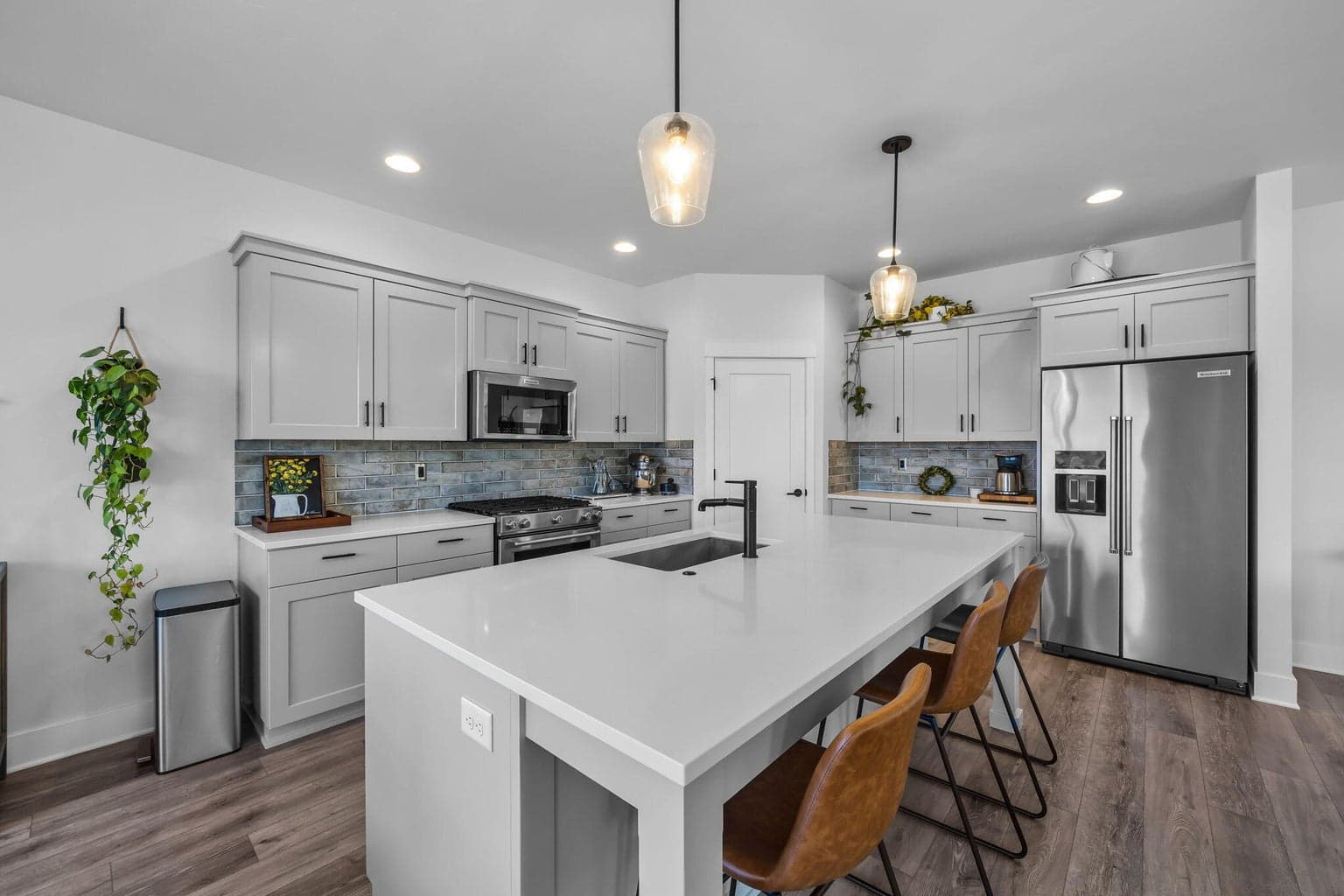 Chef-inspired kitchen w/quartz island, pantry & abundant cabinetry.