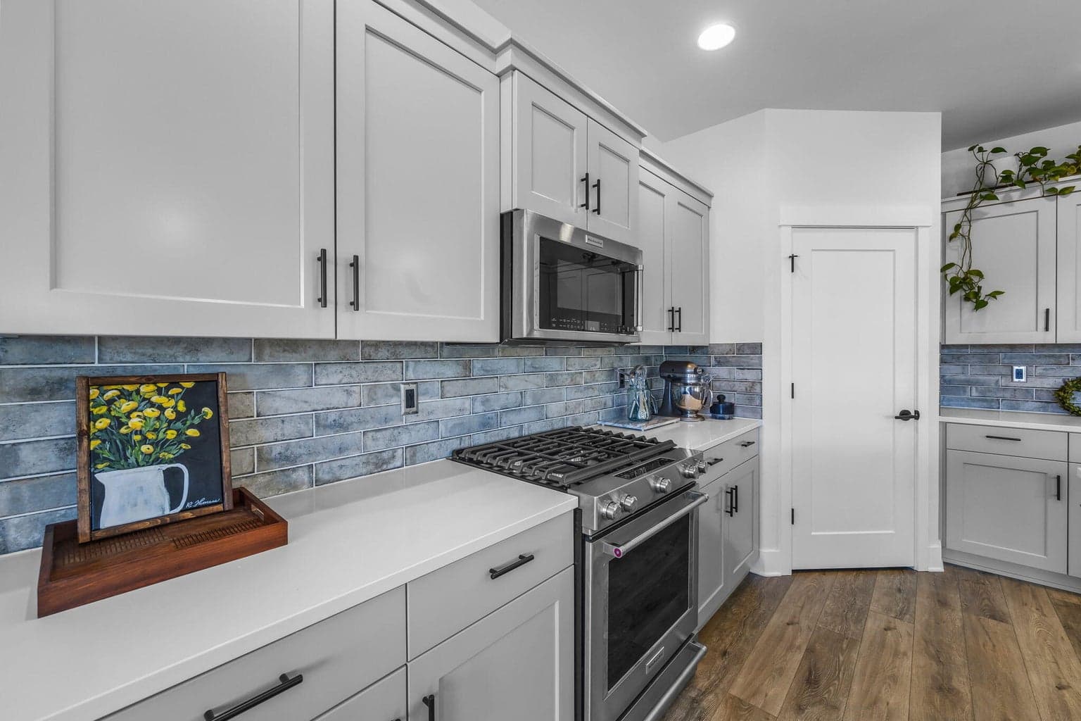 Quartz finishes & gas burning stove, corner pantry and full heigh backsplash.