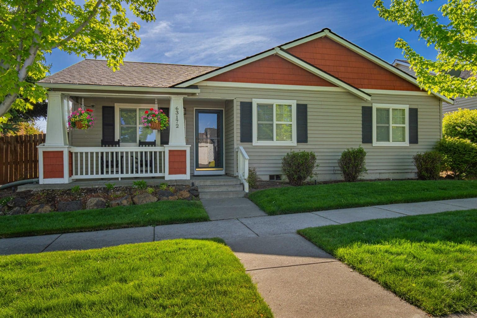 Charming single-level Bend home with a covered front porch, classic Craftsman-style details, mature landscaping, and a welcoming front entry.