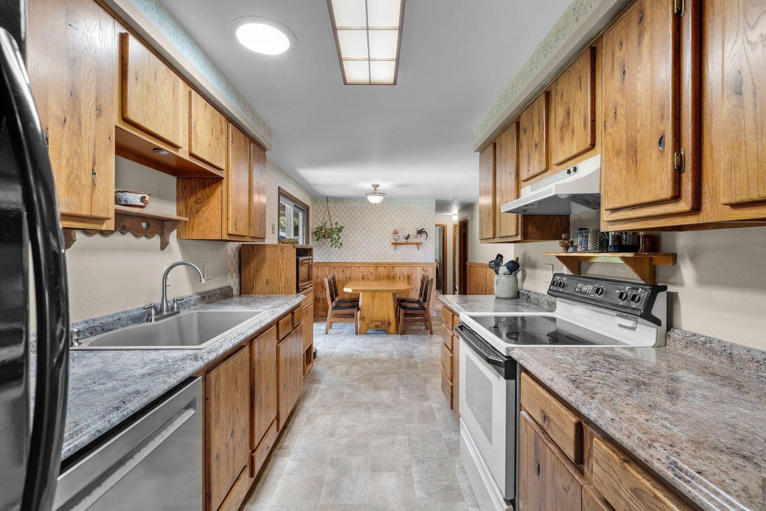 Galley kitchen w/plenty of cabinetry & prep space.
