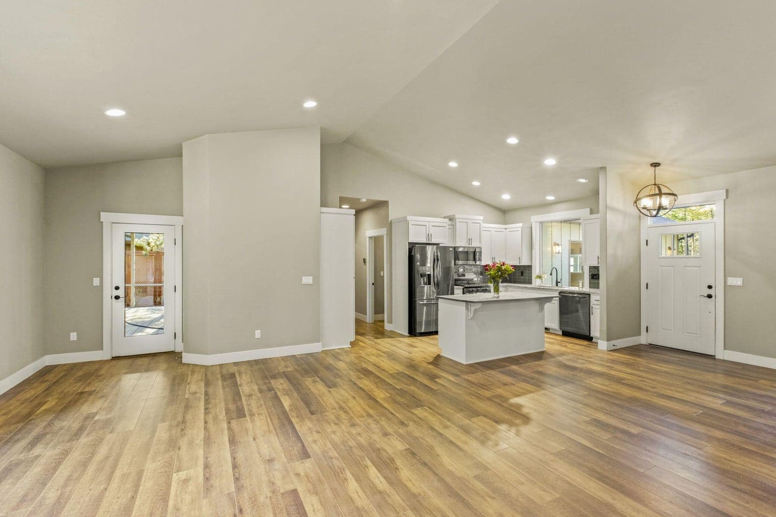 Spacious open living area with access to backyard deck.