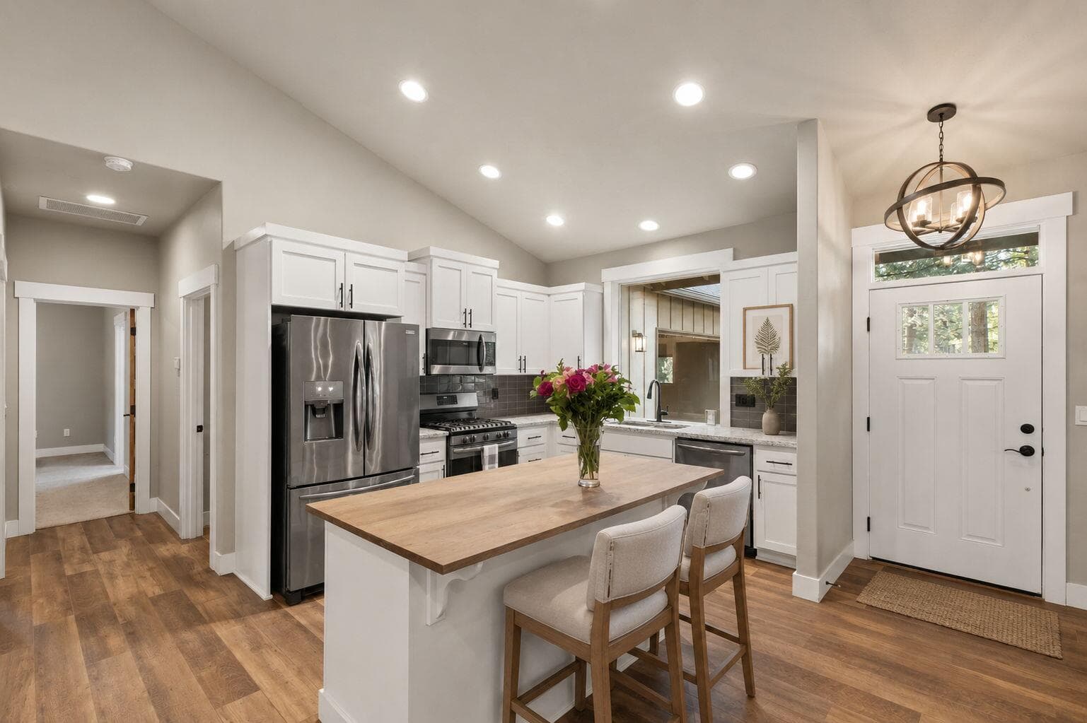 Virtually staged kitchen with island seating and modern finishes.