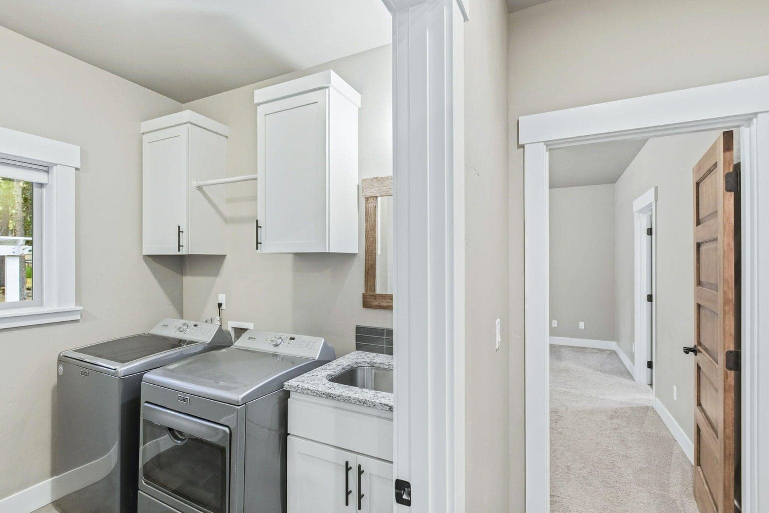 Laundry room with utility sink and extra cabinetry.