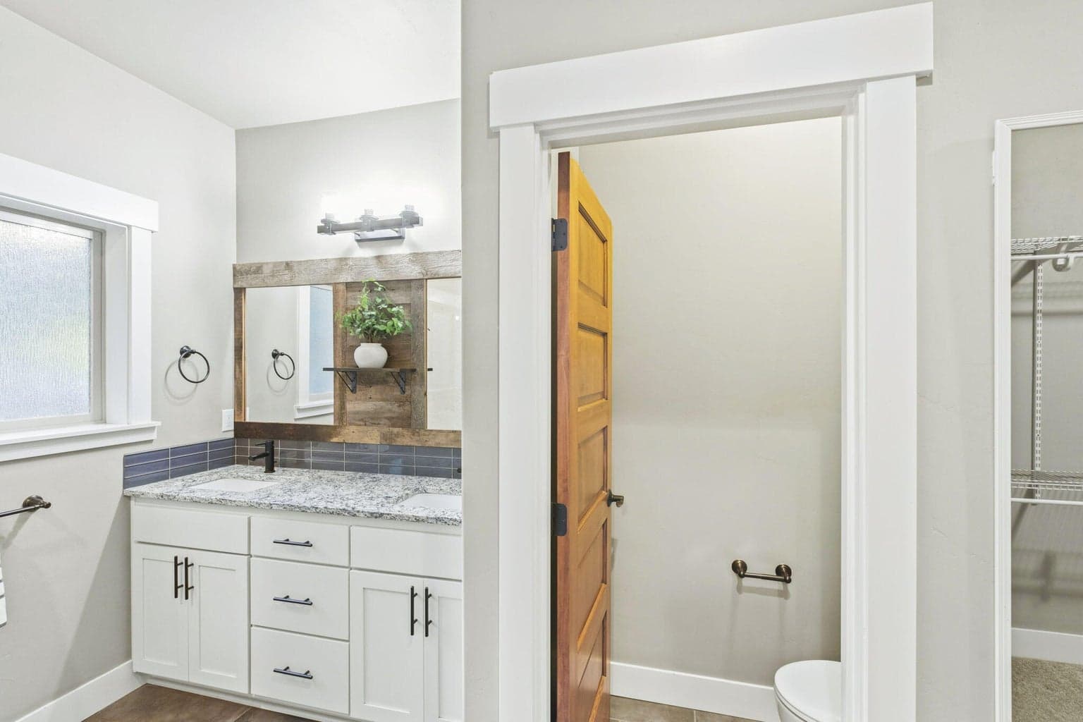 Thoughtfully designed primary suite with dual vanity and generous storage.