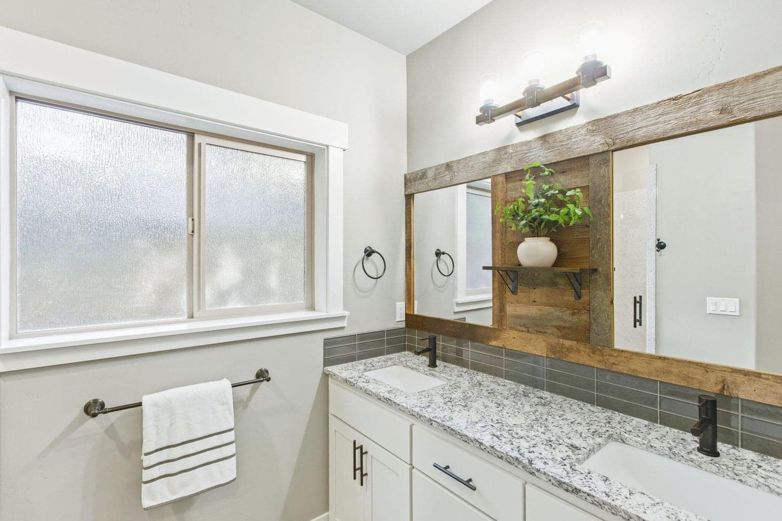 Primary bathroom, dual sinks, walk-in closet, granite counters, modern farmhouse.