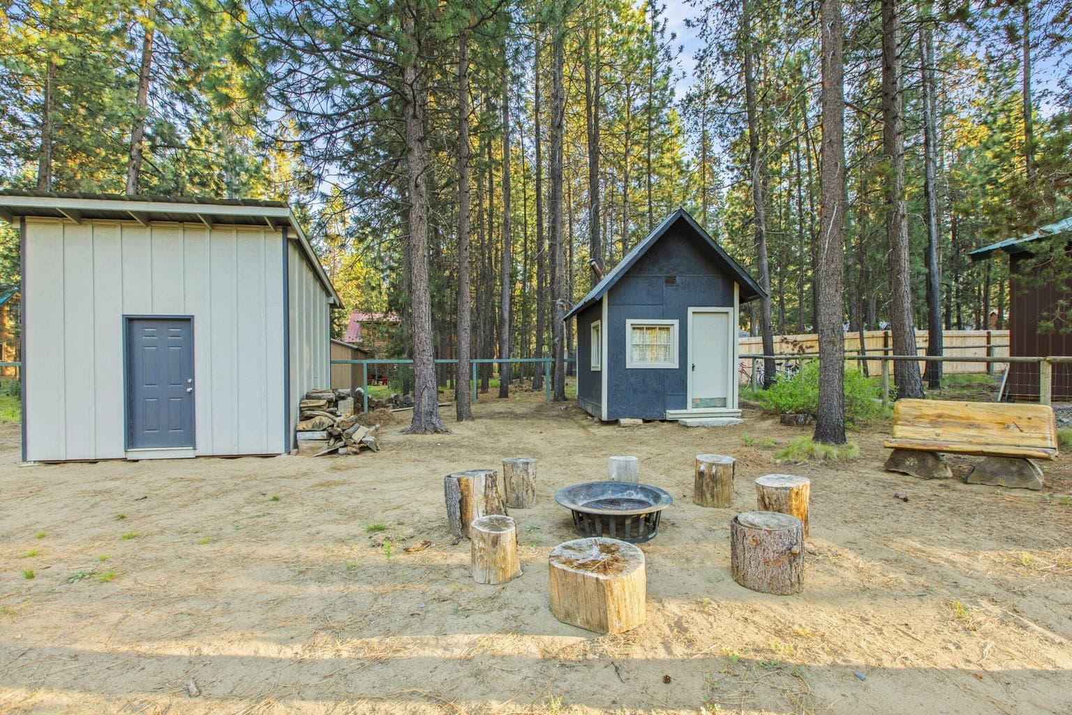 Additional outbuildings provide flexibility for storage and hobbies.