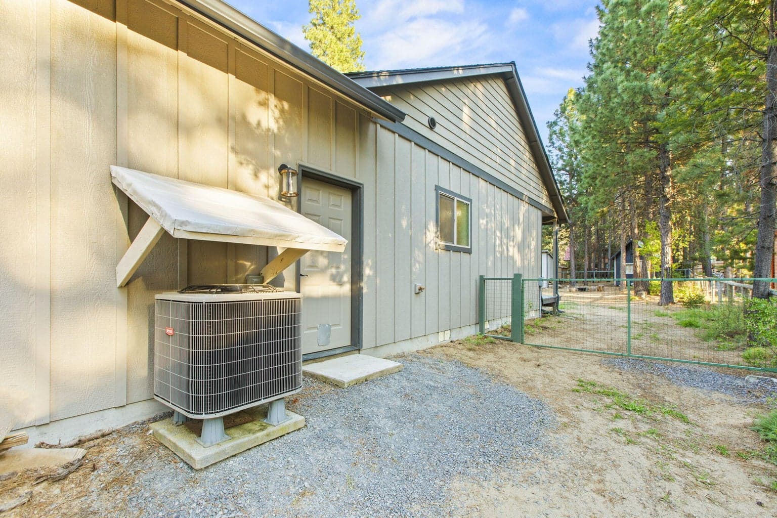 Energy-efficient heat pump system and fenced side yard offering convenience and functionality.