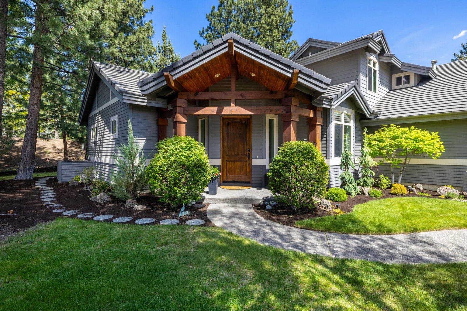 Classic Northwest architecture with warm timber accents, manicured grounds and a private, tucked-away approach within Broken Top’s Tyrion Sky neighborhood.