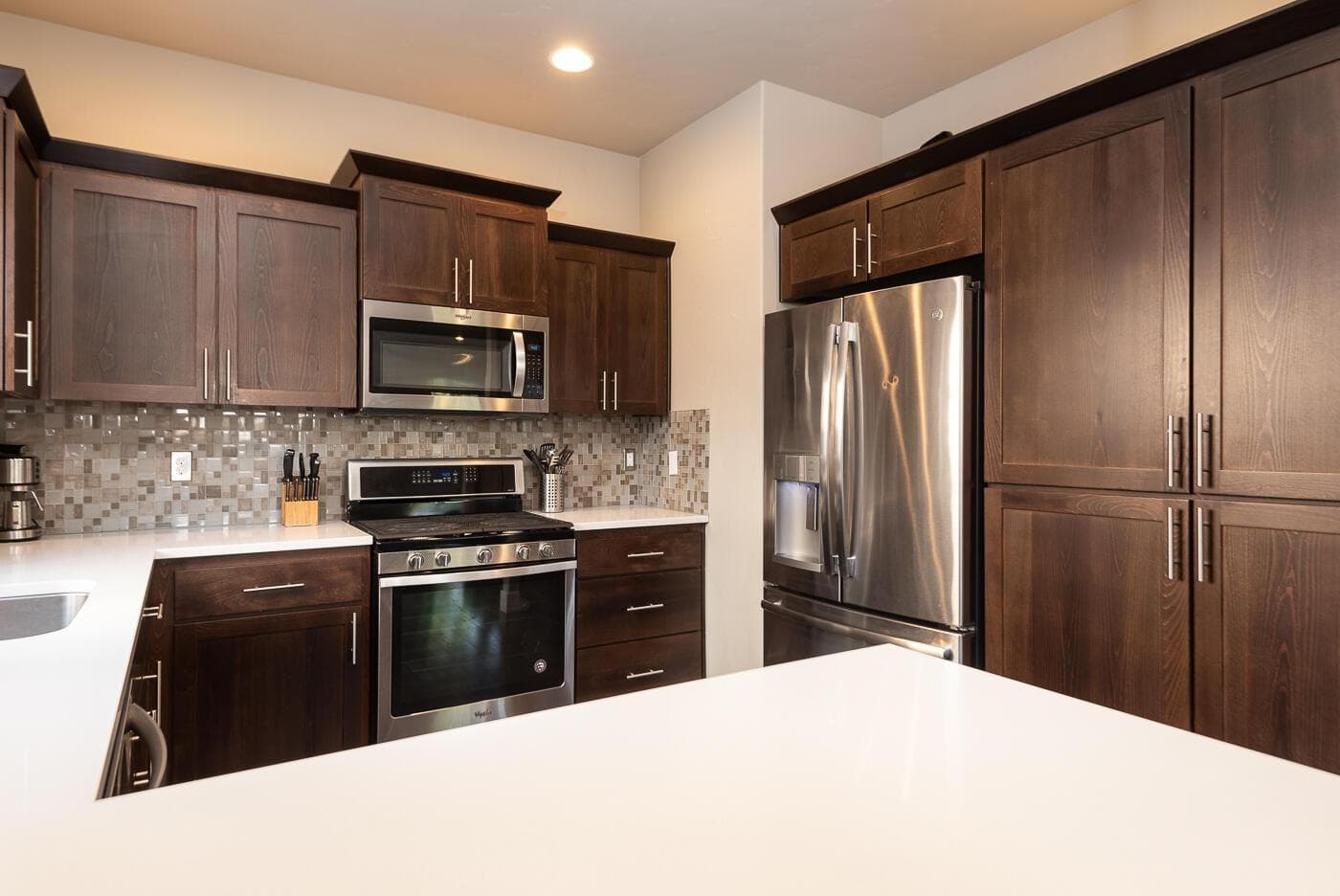 The pantry cabinetry includes pull-out drawers and deep shelving.