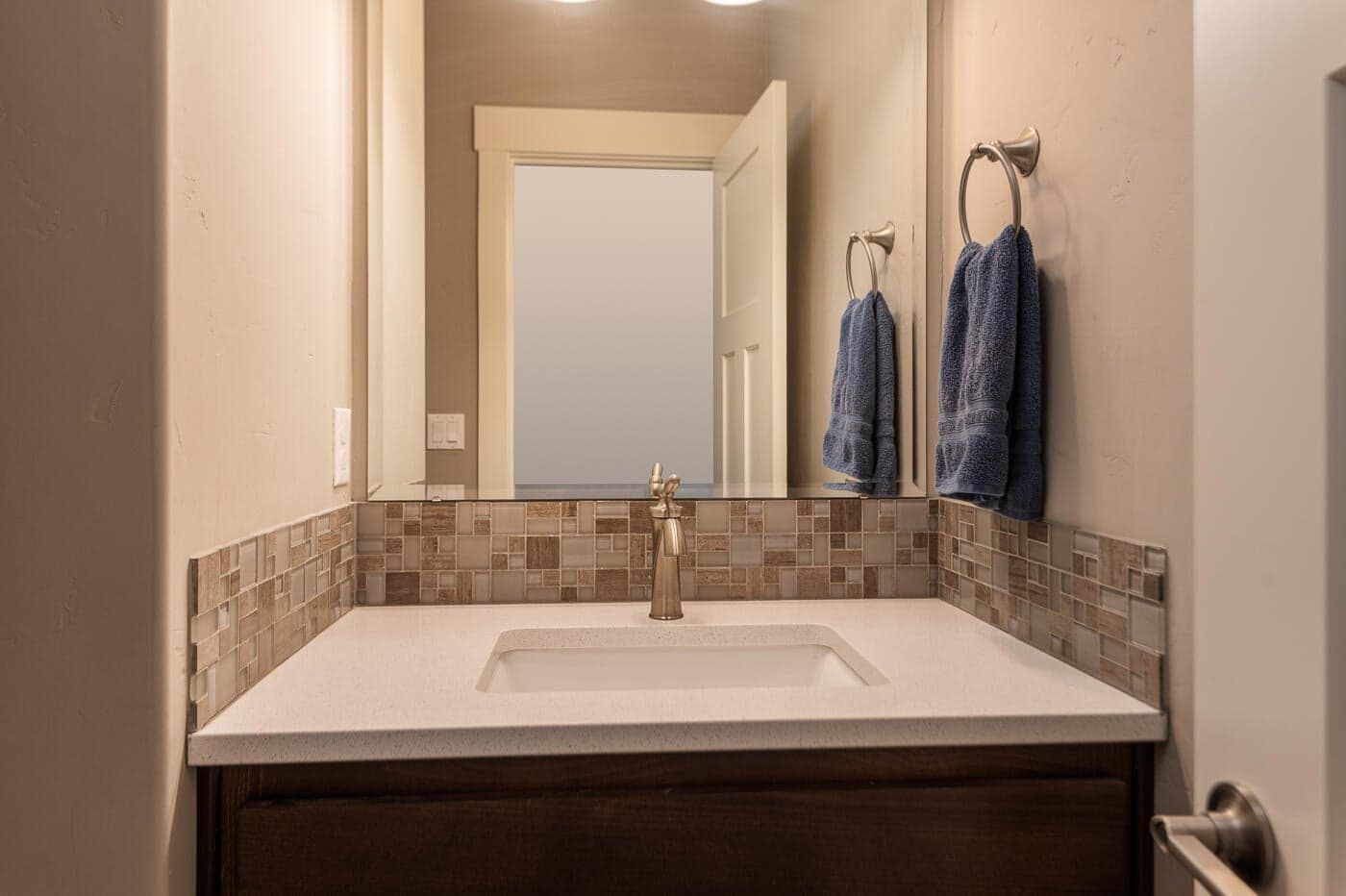 The half bath is in the hallway entrance from the garage - convenient for guests too.