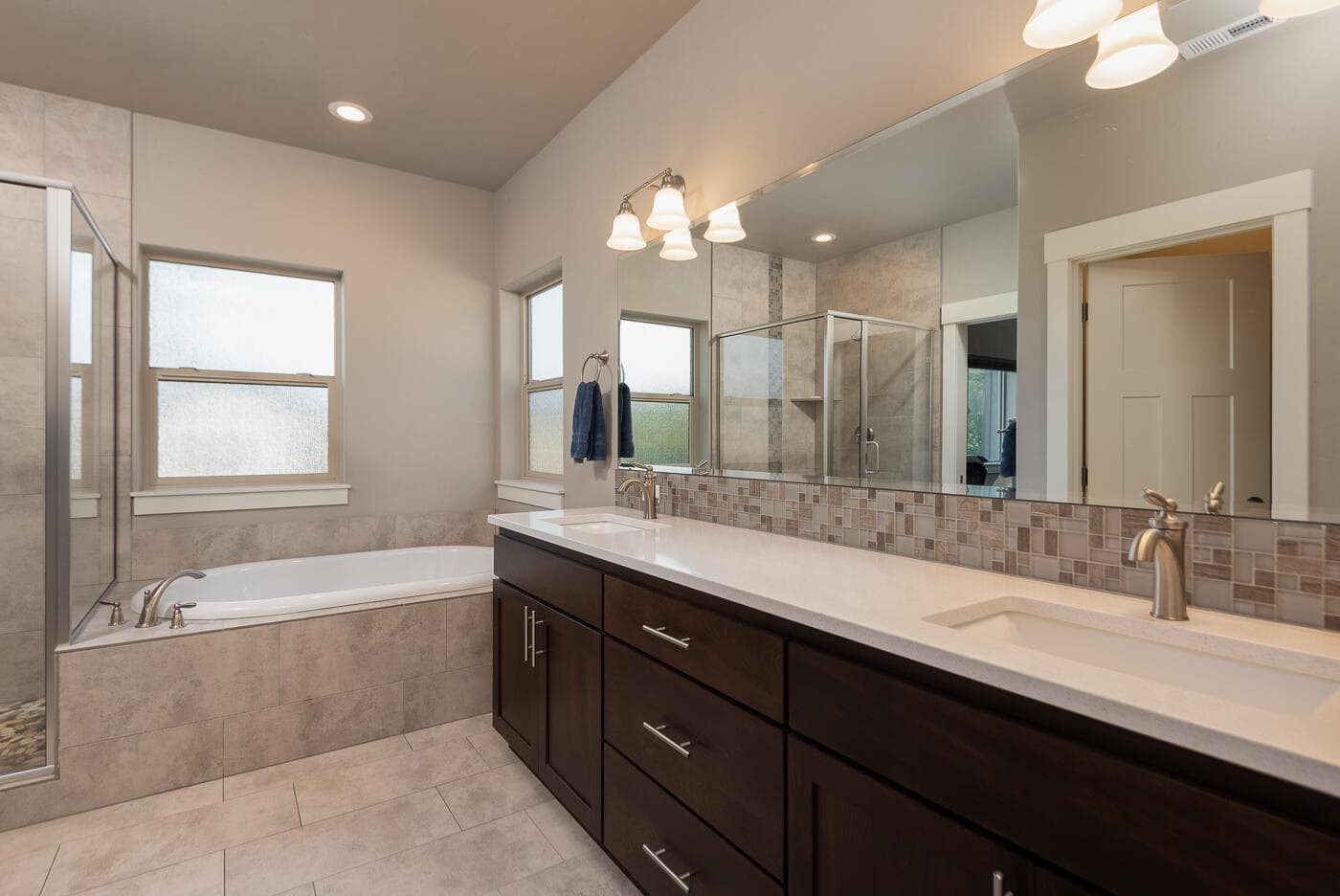 double vanity with extra drawers, amazing soaking tub and shower. Out of view is a large walk-in closet.