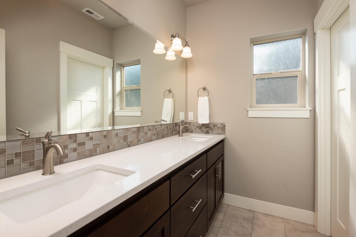 this double vanity area is thoughtfully separated from the shower/tub and toilet so two can get ready at once.