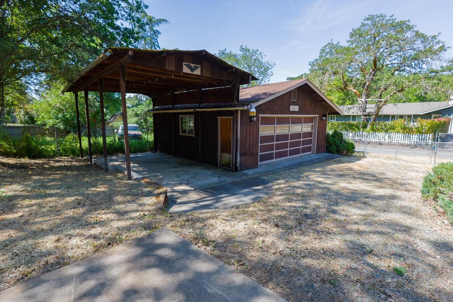 Detached 2 car garage with covered parking pad