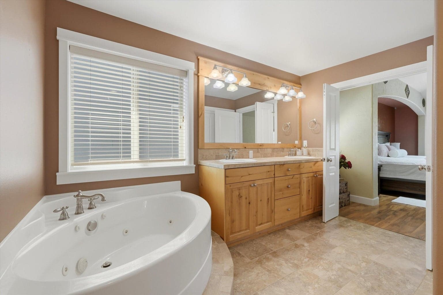 Spacious and relaxing jetted tub, with dual vanities and separate shower, and enclosed water closet