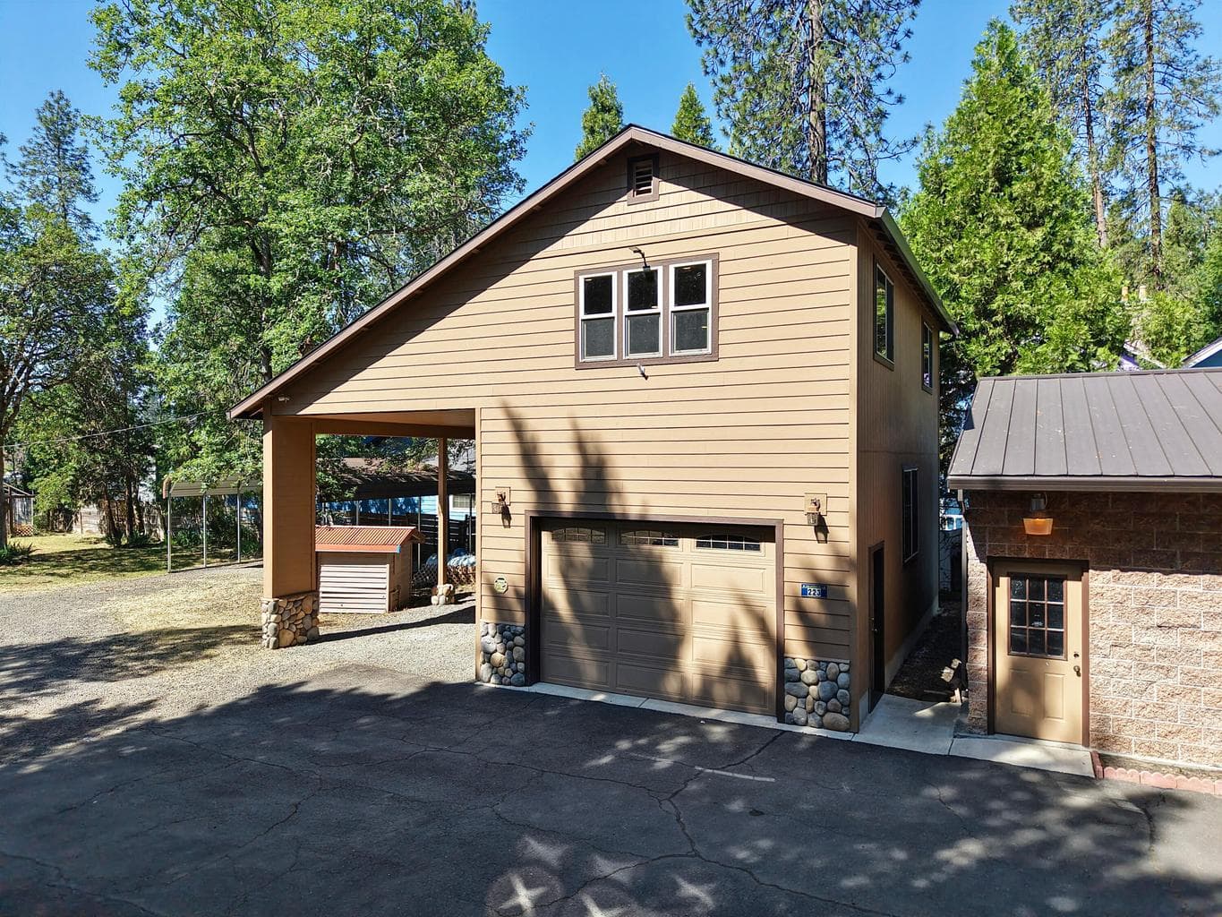 Large garage w/studio above and RV Port beside.