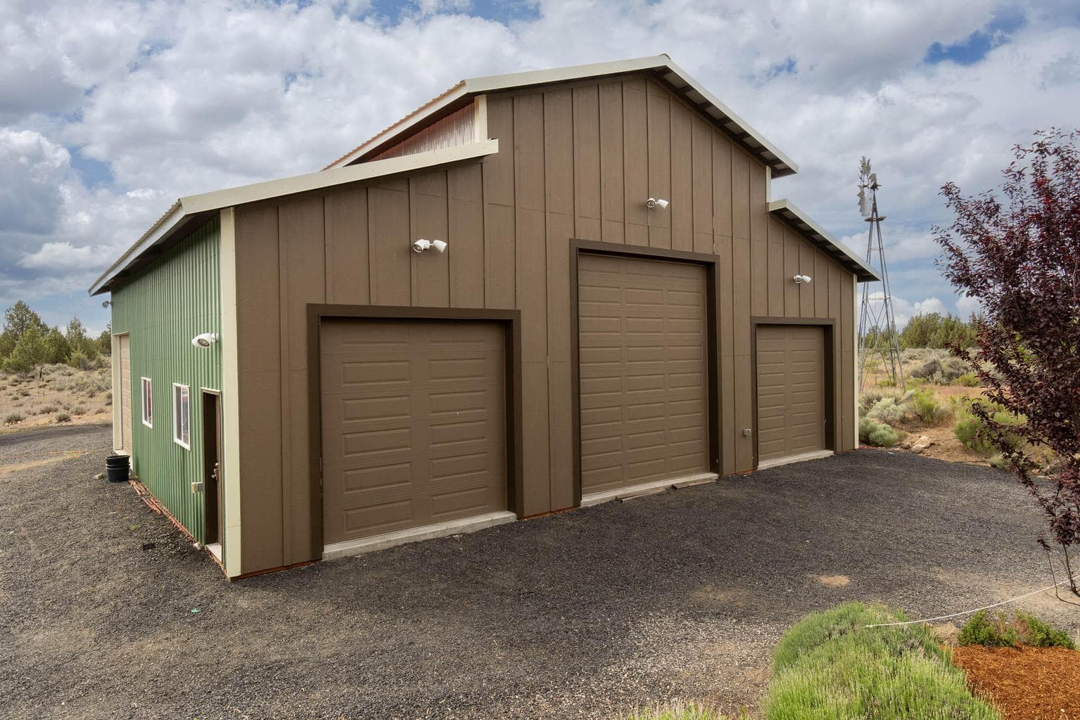 RV height drive through overhead doors, plus 3 auto overhead doors. Pwr, shop cabinets, mezzanine storage. Water to front of garage. Machine shed at rear.