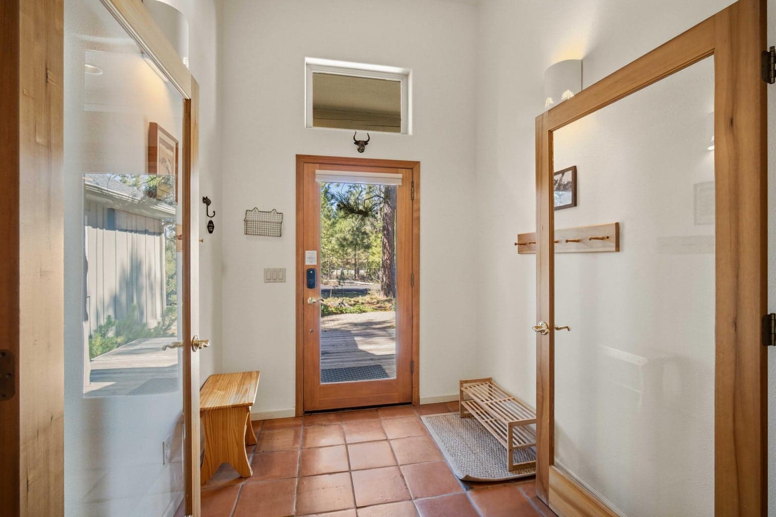 Bright entry foyer with tile flooring, wood-trimmed doors, and immediate connection to the single-level floor plan.