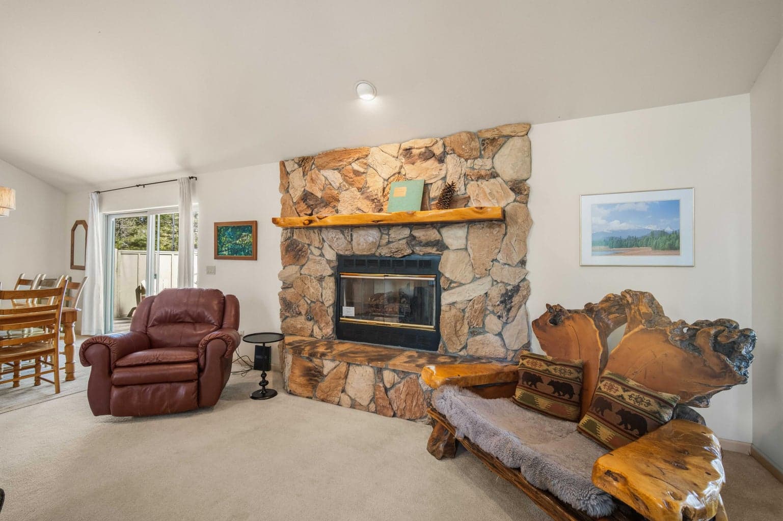 Stone fireplace and rustic wood accents create a cozy gathering point in this Sunriver vacation or full-time residence.