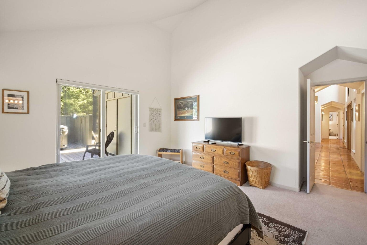Bedroom suite view showing deck access, generous scale, and connection to the hall and bathroom areas.
