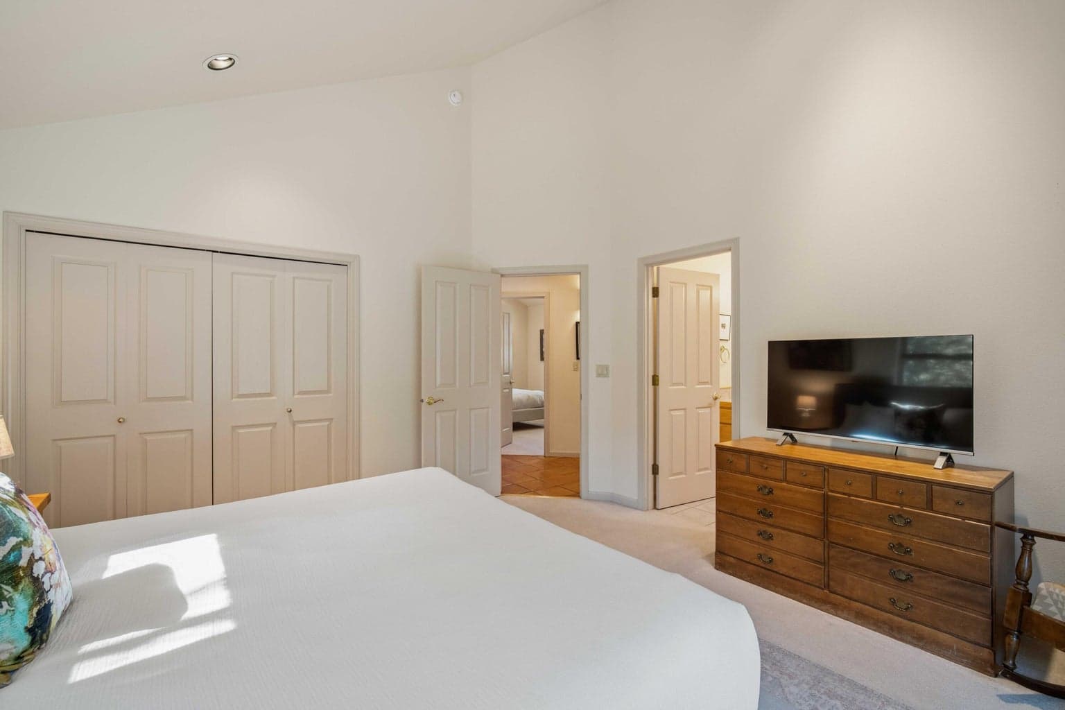 Additional view of the second suite, showing closet access, hall connection, and a comfortable bedroom layout.