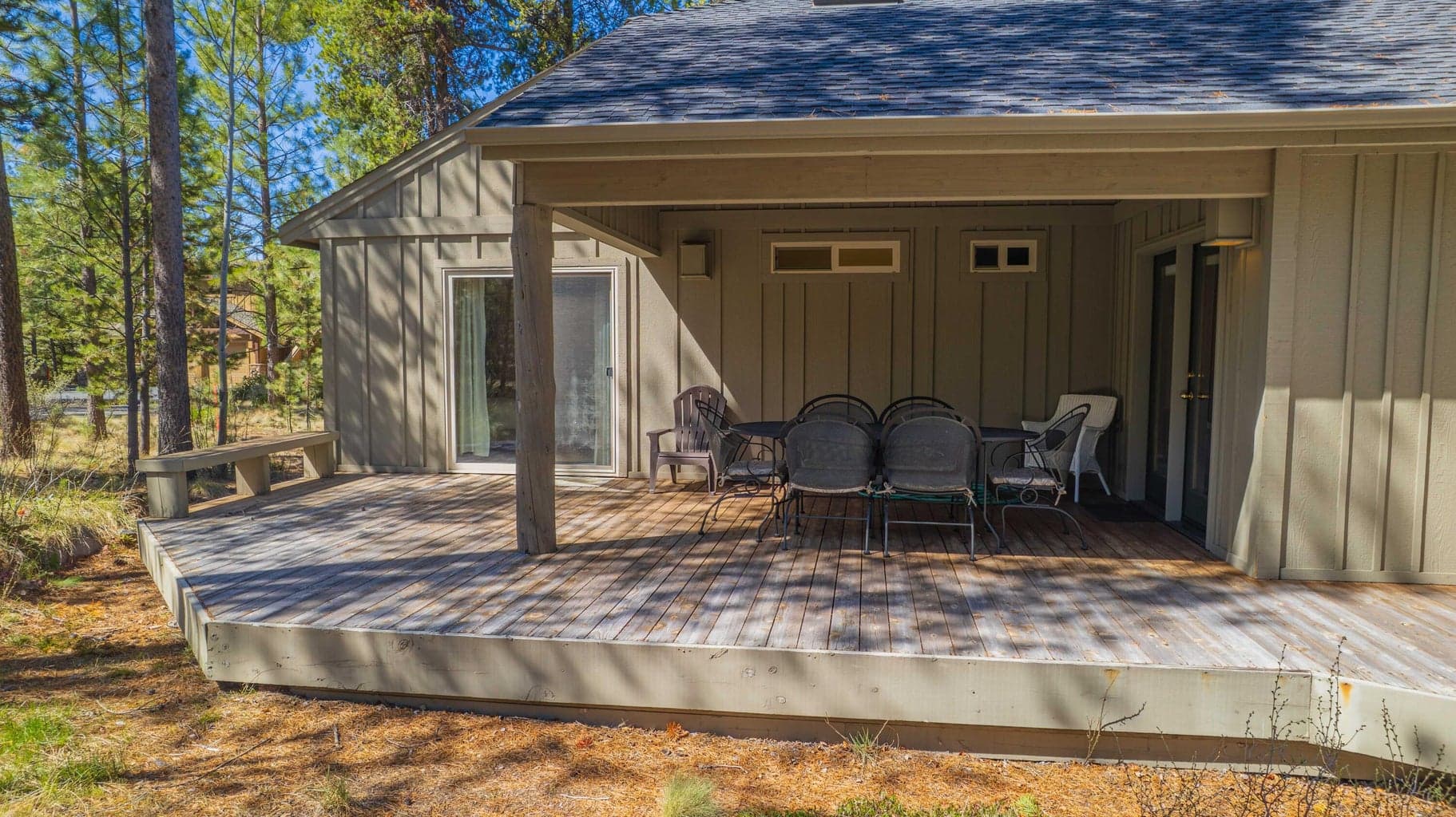 Covered back deck close-up with dining area and access from the main living spaces and bedroom wing.