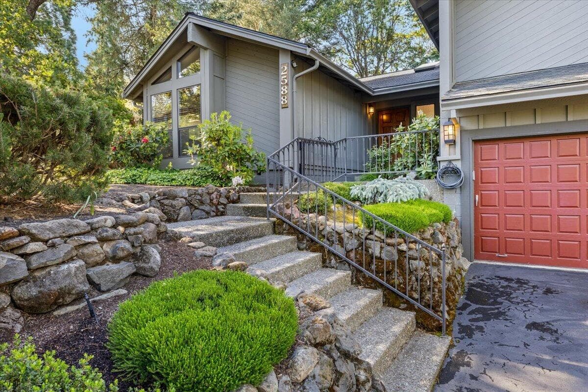 Front of home, with steps and rock wall
