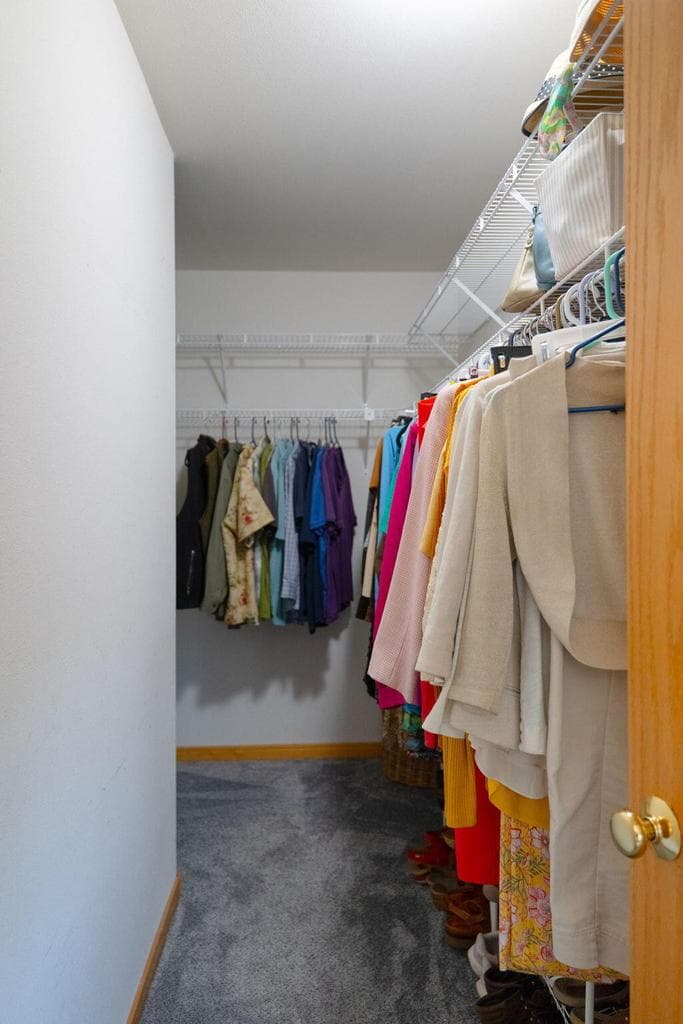 Walk-in closet goes around the corner.