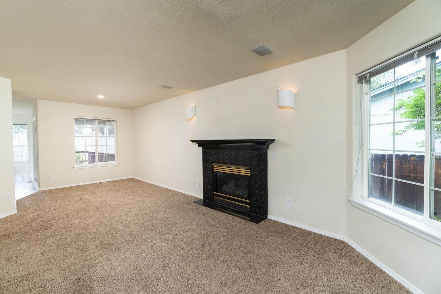 Nice wall sconces on both sides of the living room fireplace.