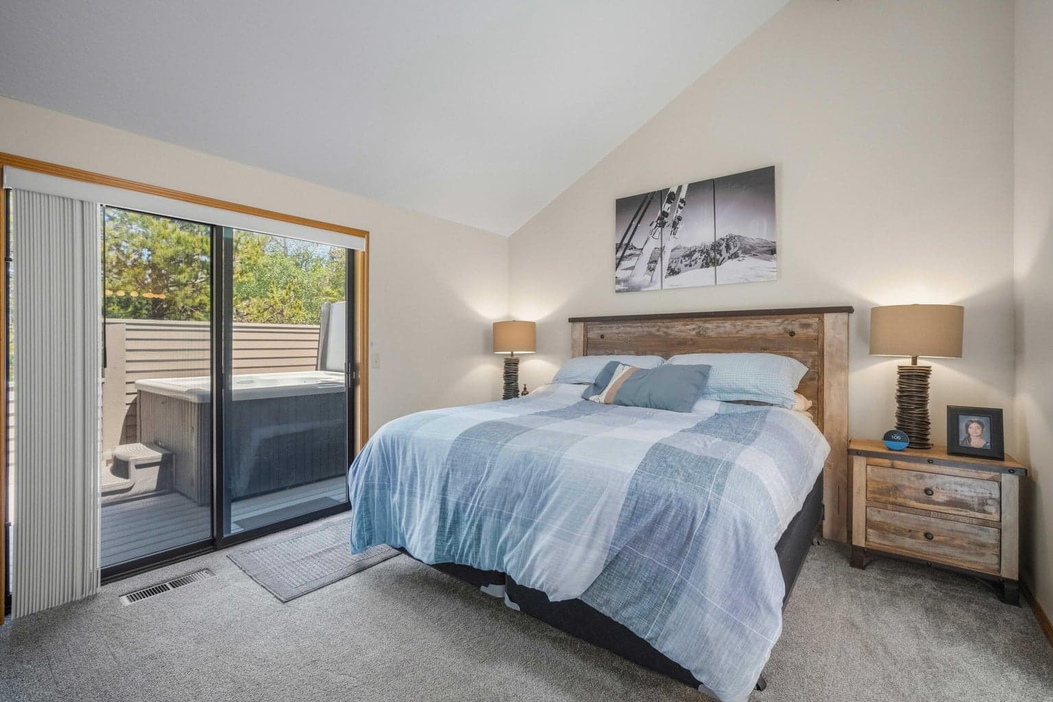 Main-level primary suite with deck access and private bath nearby.