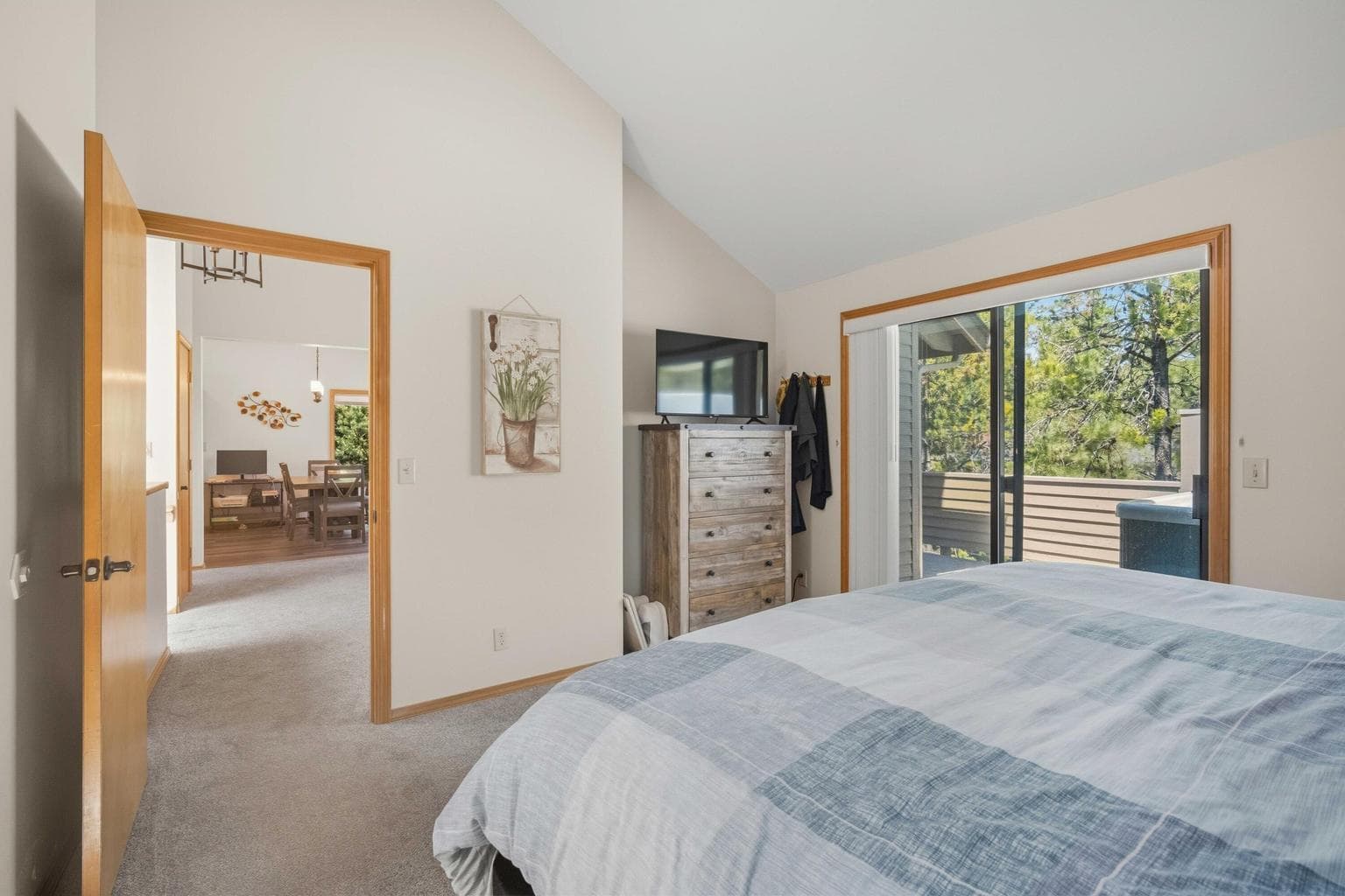 Primary bedroom opens directly to the upper deck and hot tub area.