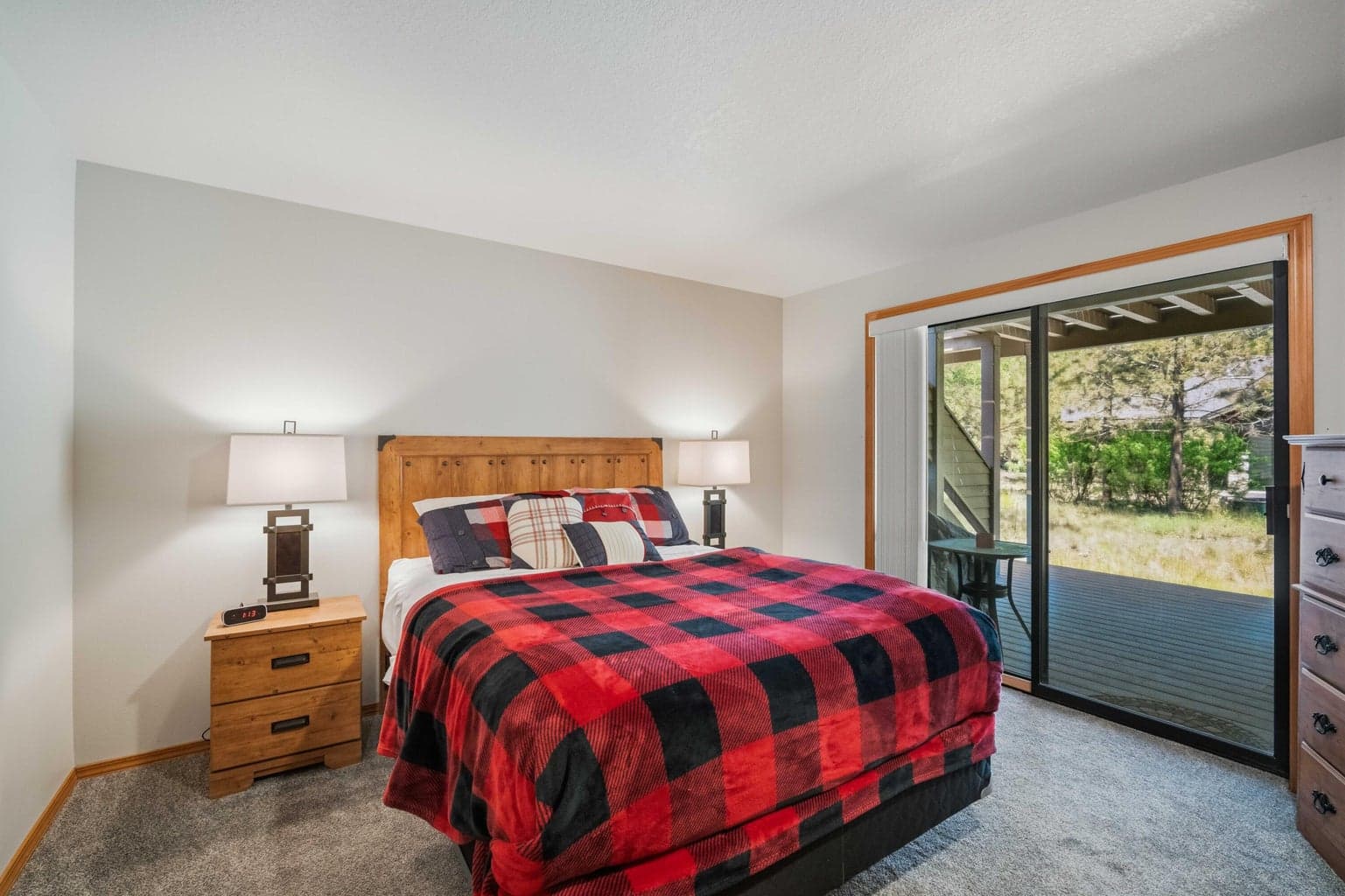Lower-level guest bedroom with sliding door access to the covered lower deck.