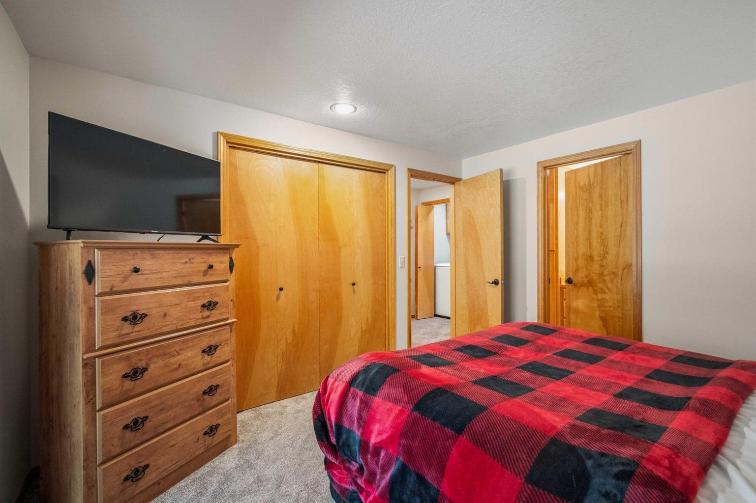 Lower-level bedroom with direct access to the guest bathroom, creating a flexible suite-like layout.