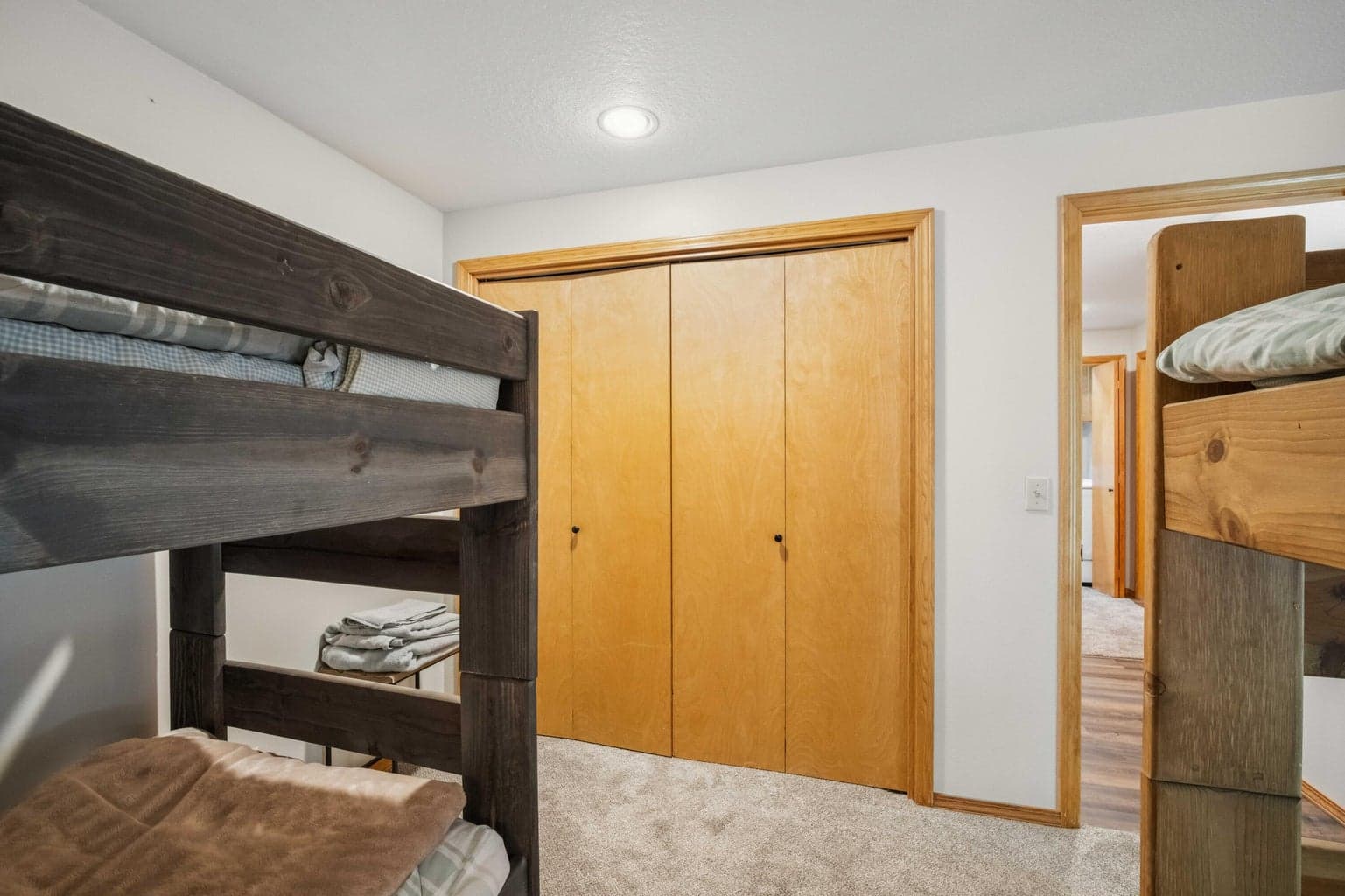 Bunk room with closet storage and easy access to the lower-level hall.