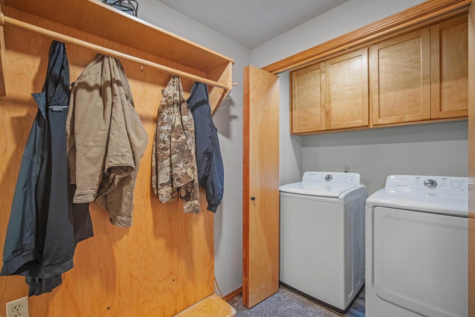 Lower-level laundry and mudroom area with built-in storage near the guest bedrooms.