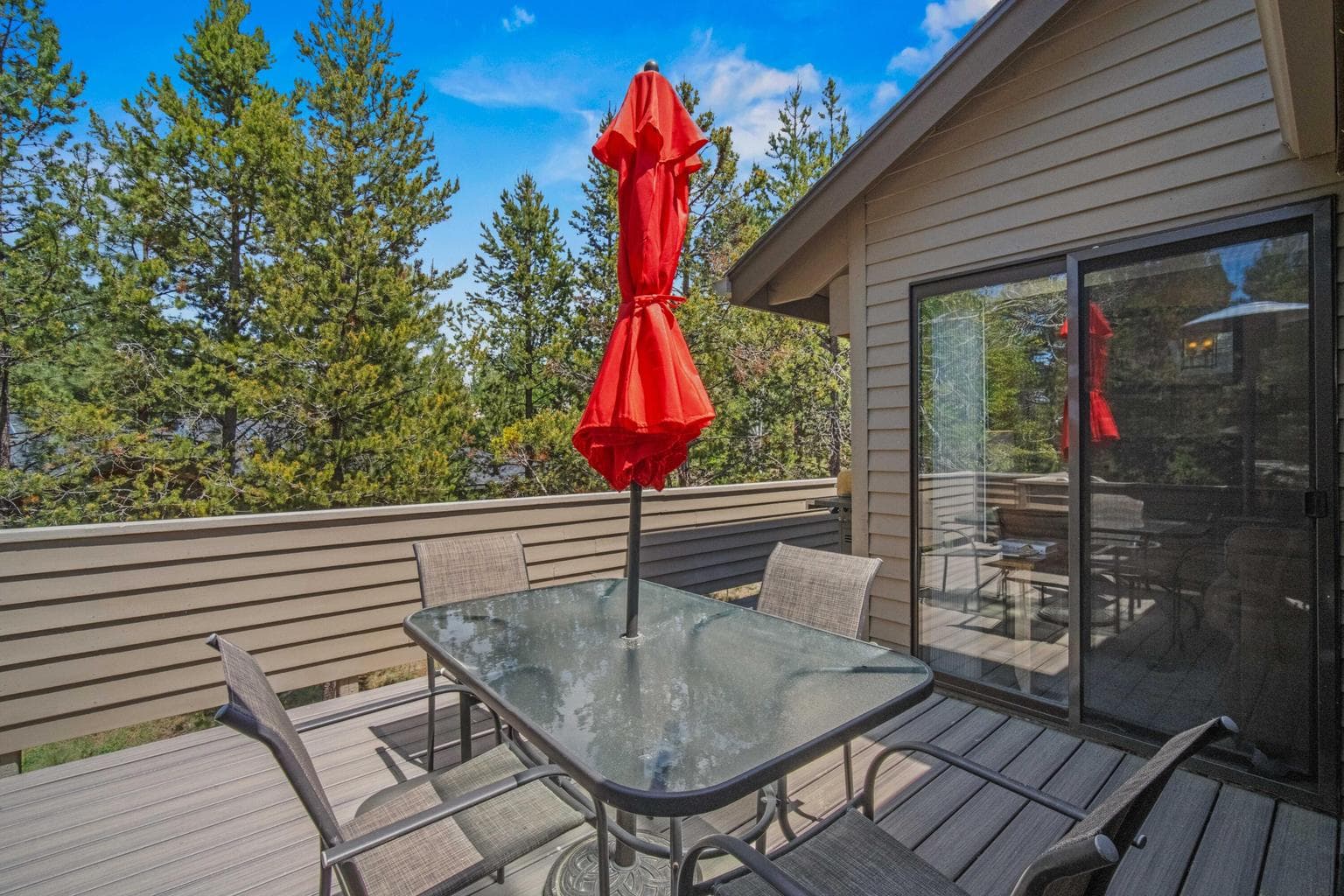 Upper deck off the main living area, ideal for outdoor meals among the pines.