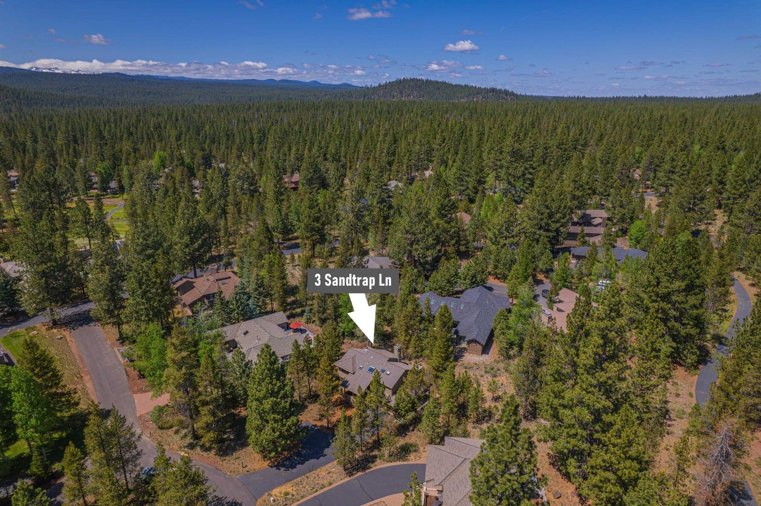 Aerial neighborhood view identifying the home’s quiet Sandtrap Lane location.